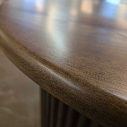 Close-up of a wooden table surface with a blurred background