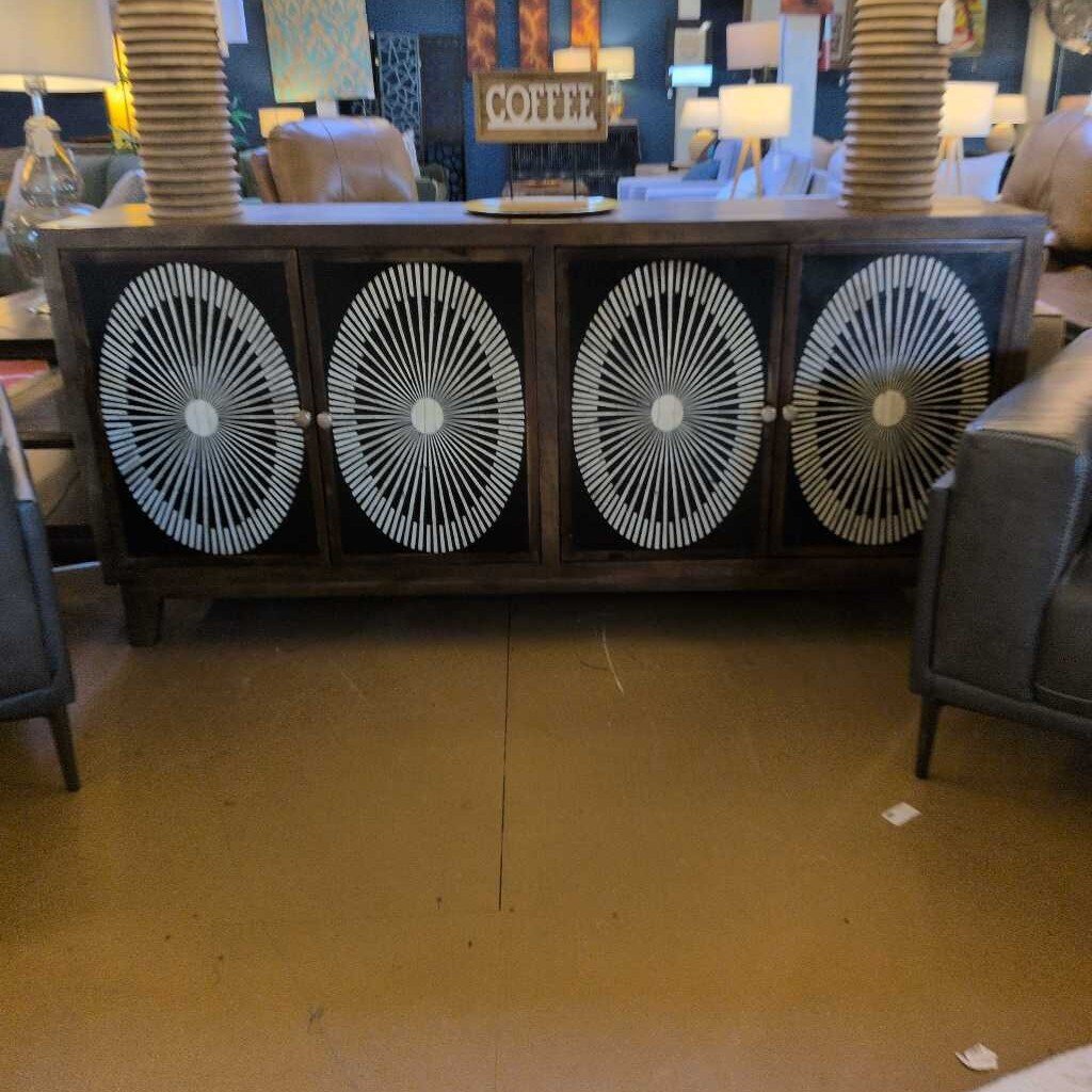 Furniture store interior with decorative cabinet and chairs.