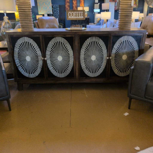 Furniture store interior with decorative cabinet and chairs.