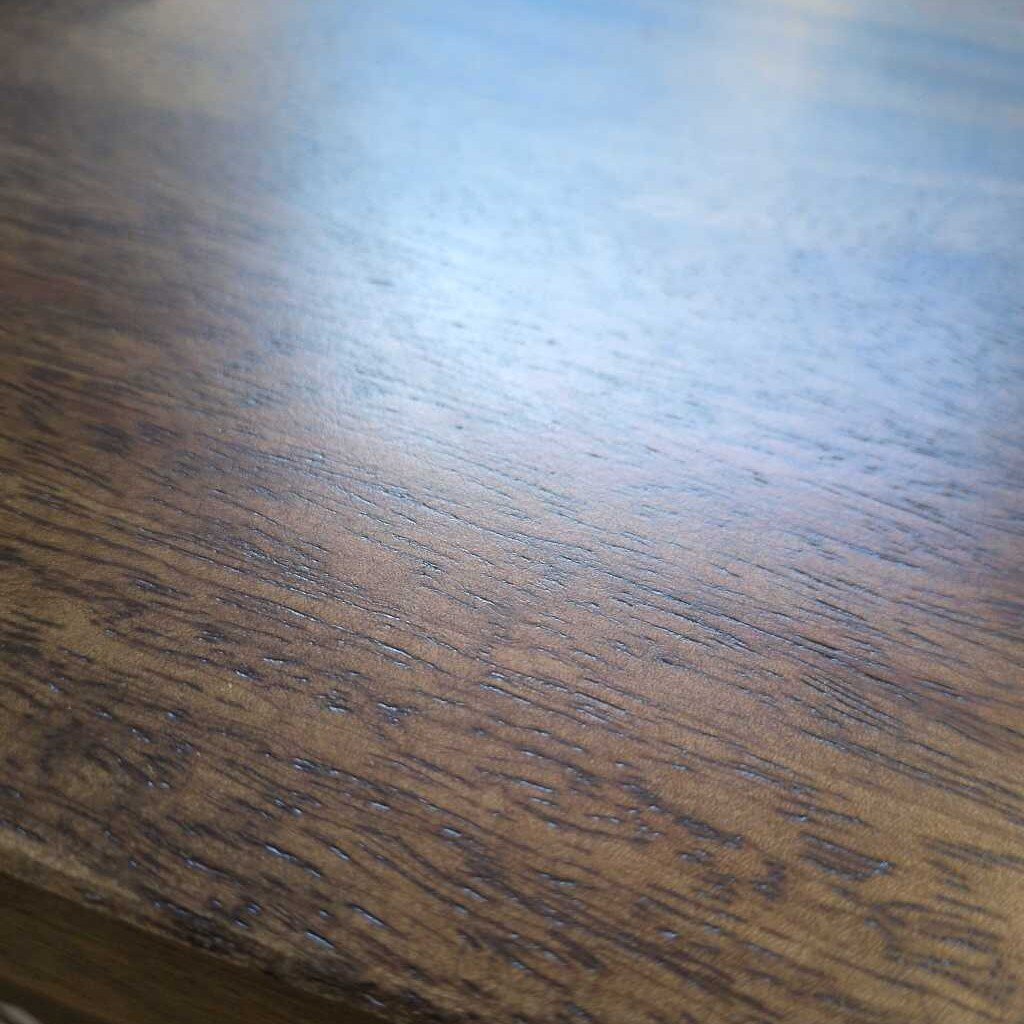 Close-up of a wooden surface with visible grain and texture.