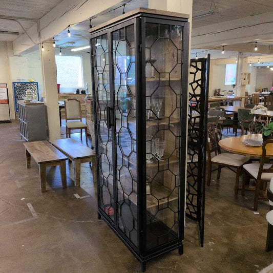 Decorative glass cabinet in a room with tables and chairs