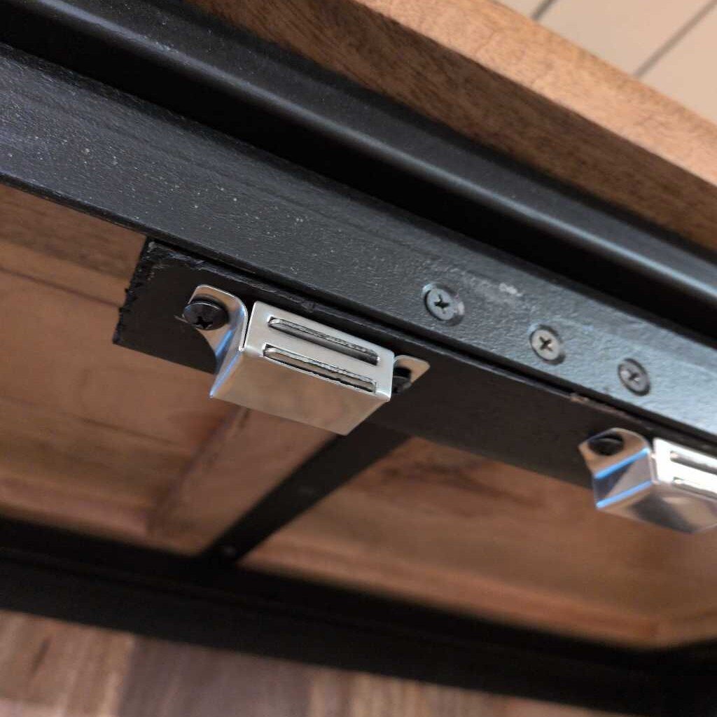 Close-up of a metal bracket on a wooden surface