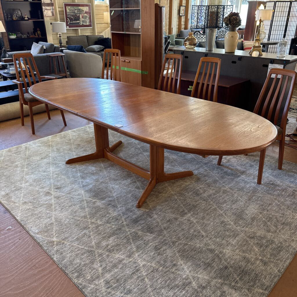 Wooden dining table with chairs in a showroom setting