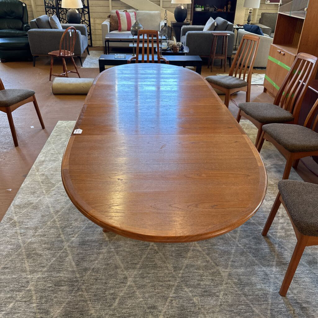 Wooden dining table with chairs in a furniture store setting
