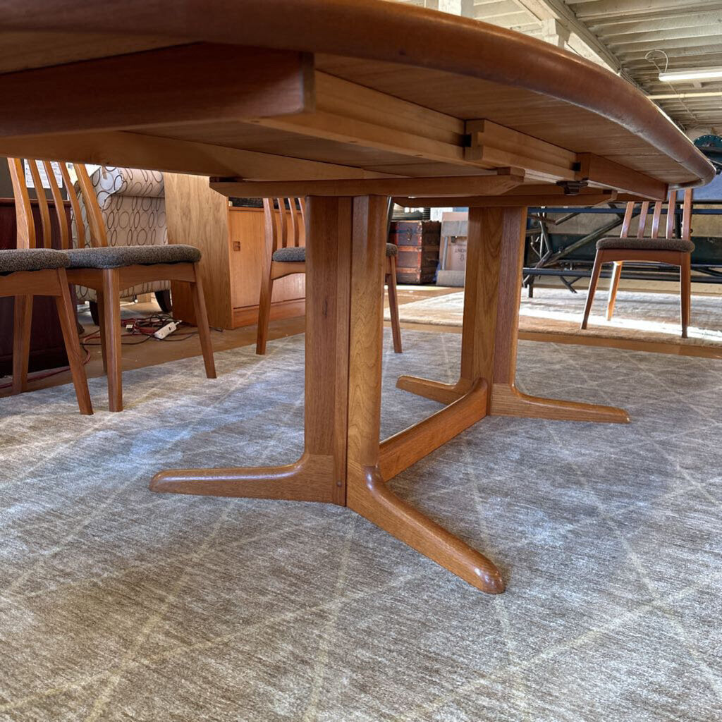 Wooden dining table with chairs in a room setting