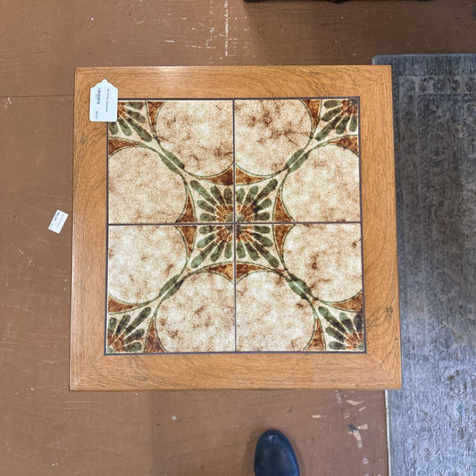 Decorative tile with floral pattern on a wooden frame