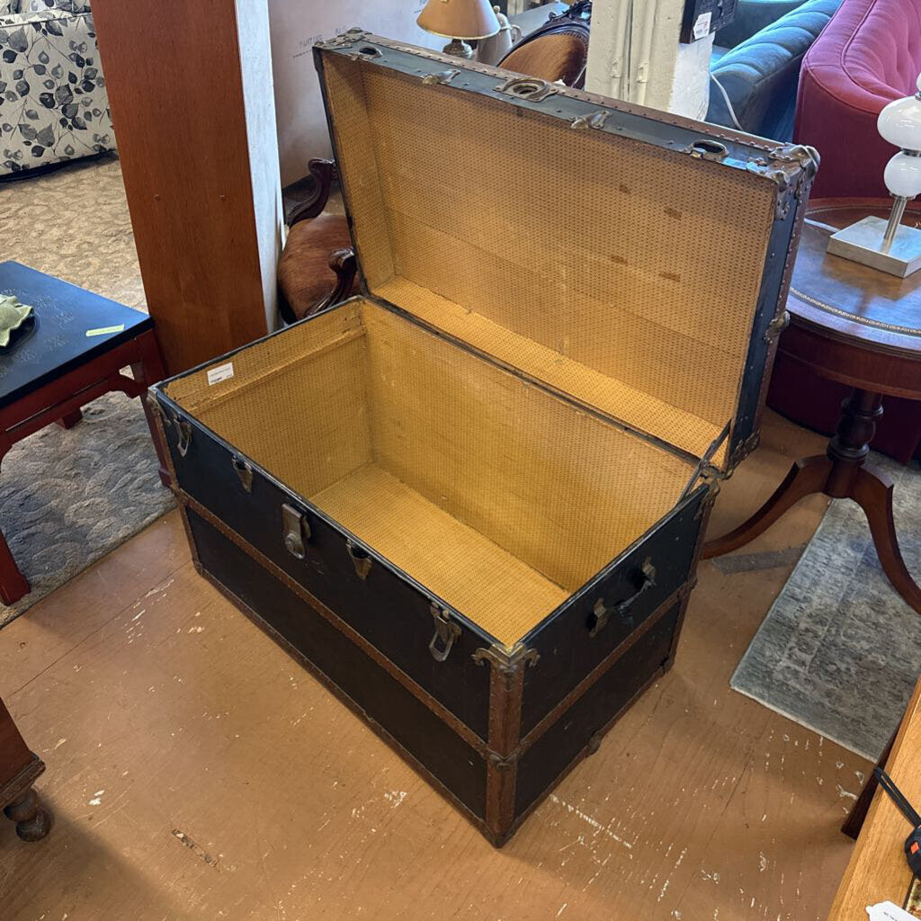 Vintage suitcase with wicker interior on a wooden floor