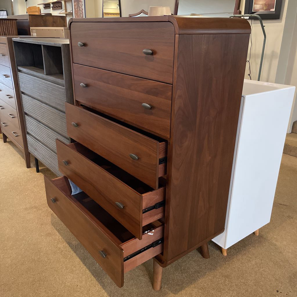 Wooden dresser with multiple drawers in a store setting