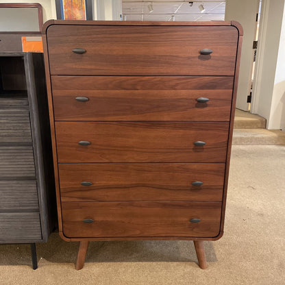 Wooden dresser with four drawers in a store setting