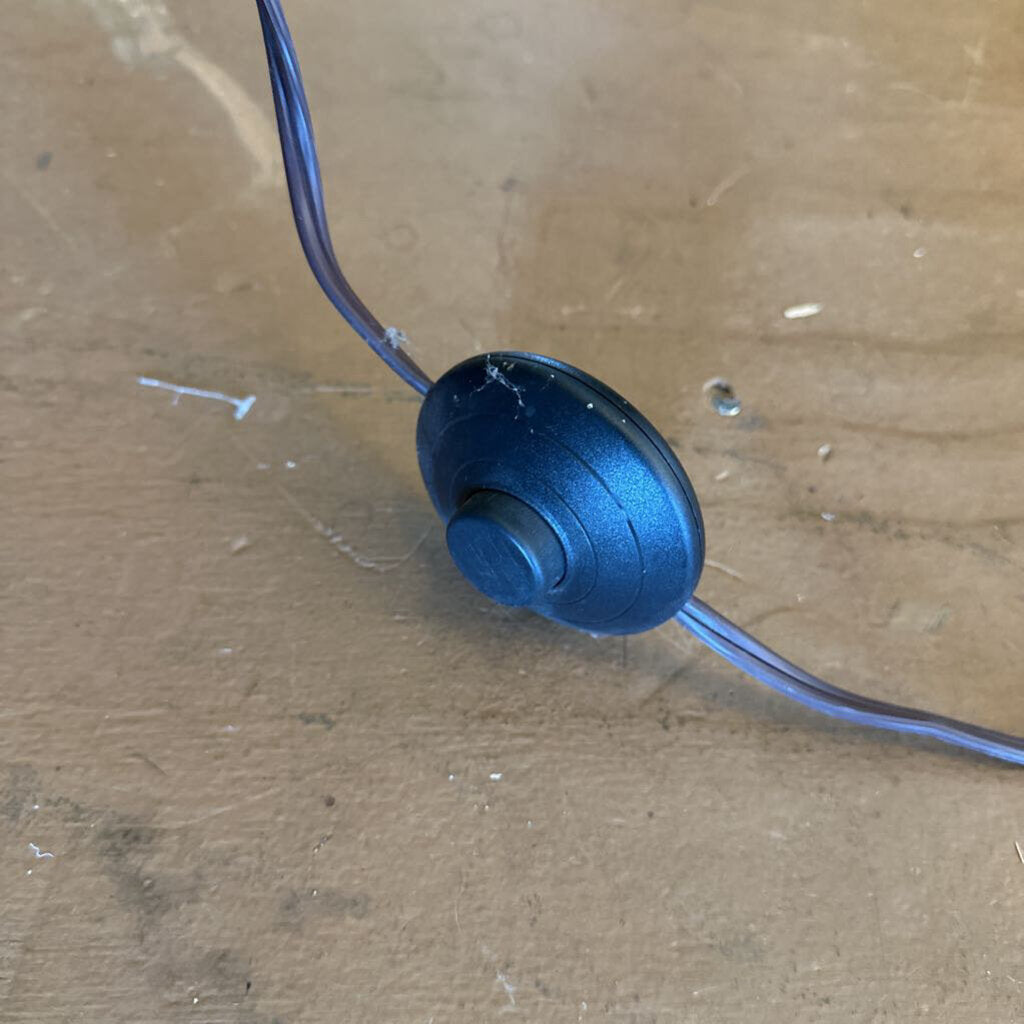Blue cable end with a metal connector on a wooden surface