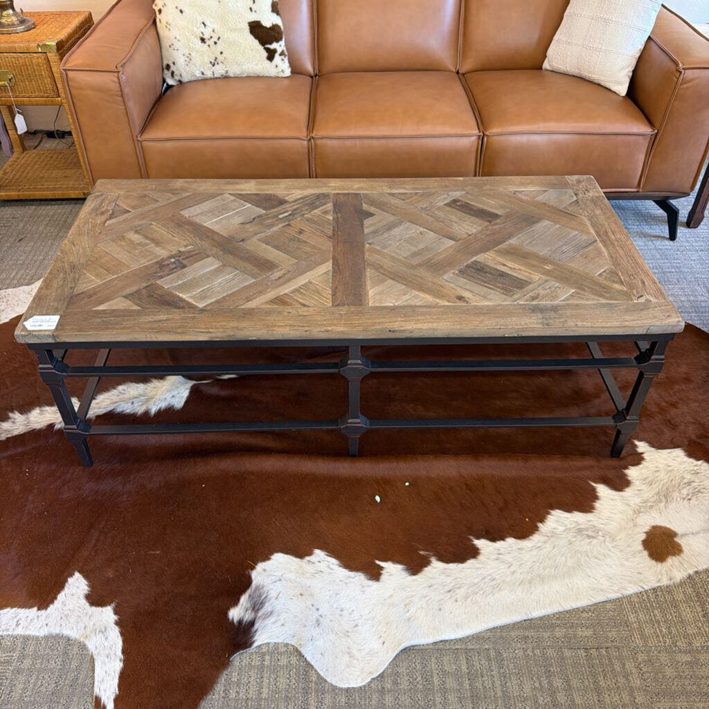 Brown leather sofa with a wooden coffee table in a room setting.