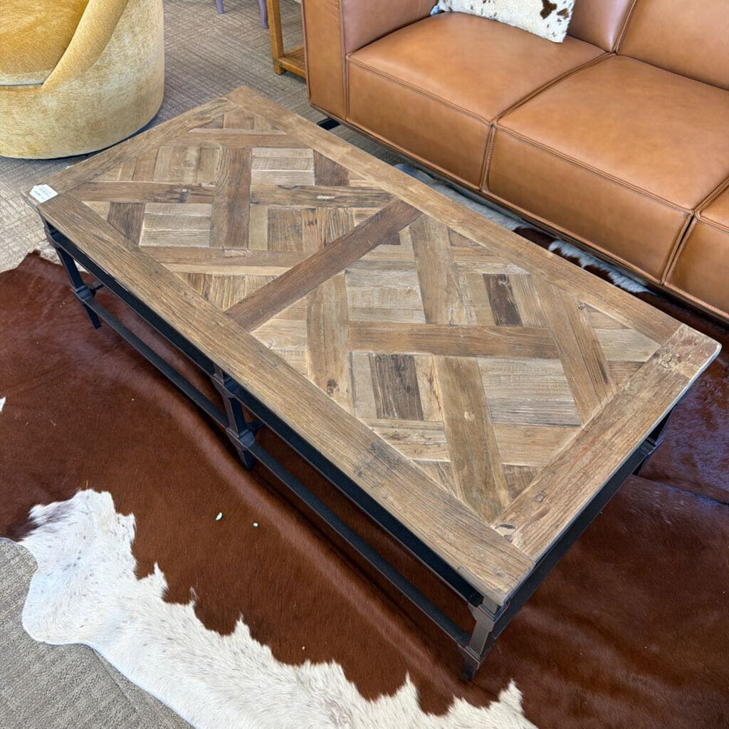 Wooden coffee table with herringbone pattern in a living room setting