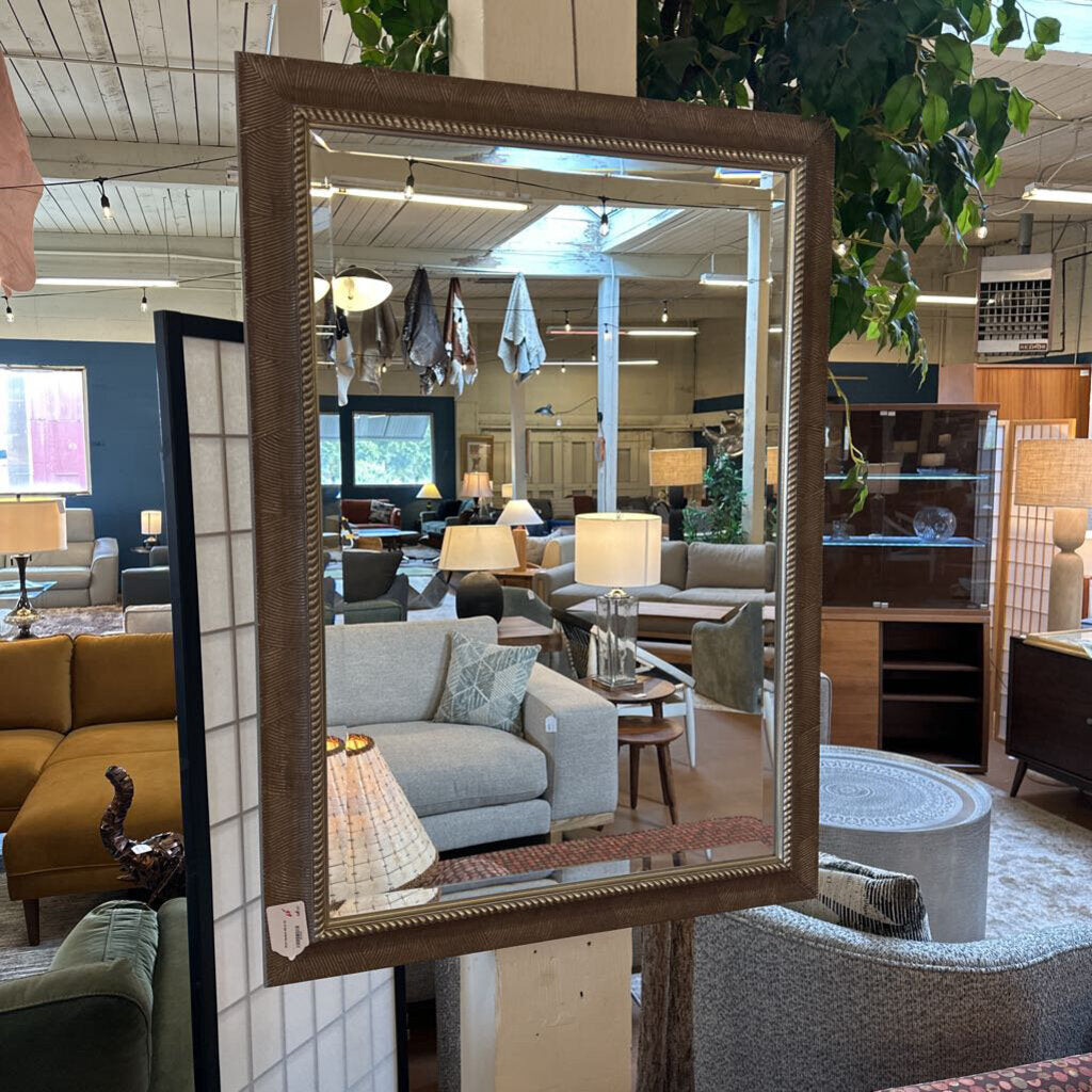 Decorative mirror in a furniture store with living room furniture in the background