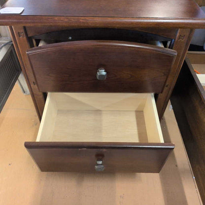 Wooden drawer with a metal handle on a wooden surface