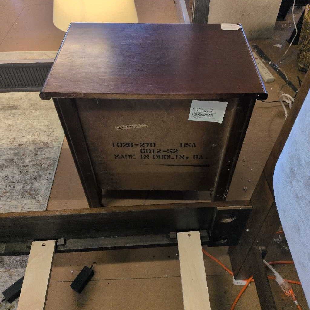 Wooden cabinet with a label on a floor