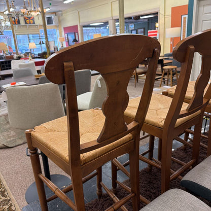 Wooden bar stools with cushioned seats in a casual dining setting.