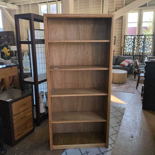 Wooden bookshelf in a room with furniture and decor