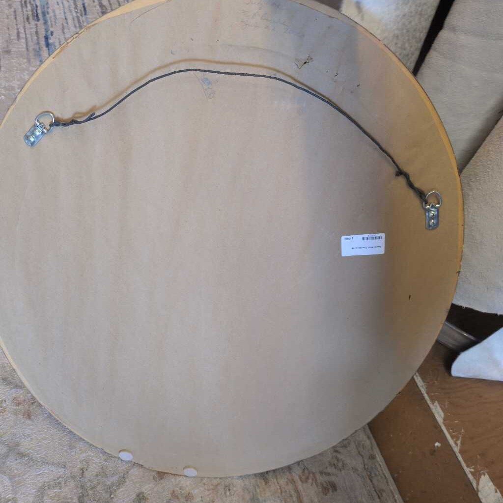Round wooden object with wiring on a textured surface