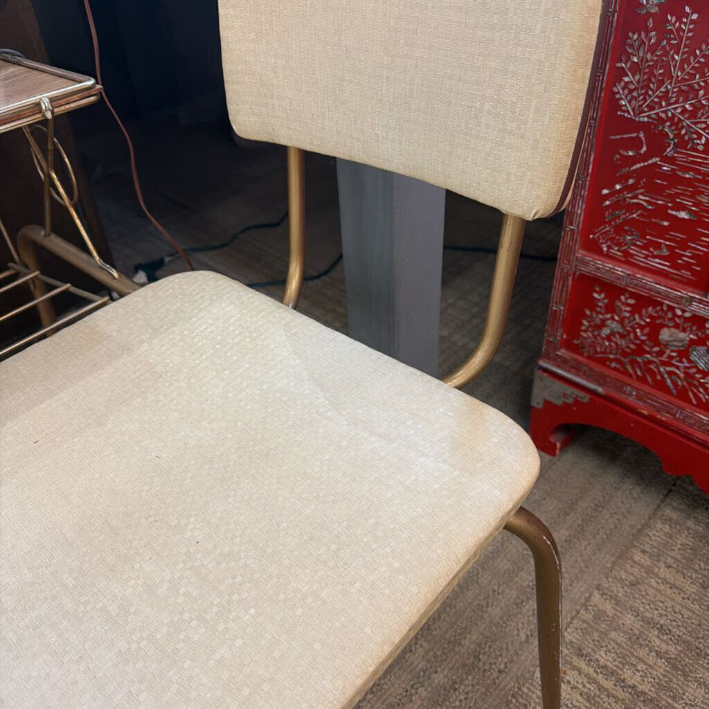 Wooden shelf with pink object and gold hangers in a room setting
