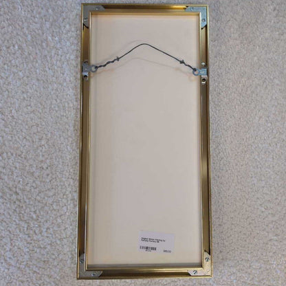 Gold picture frame on a textured wall