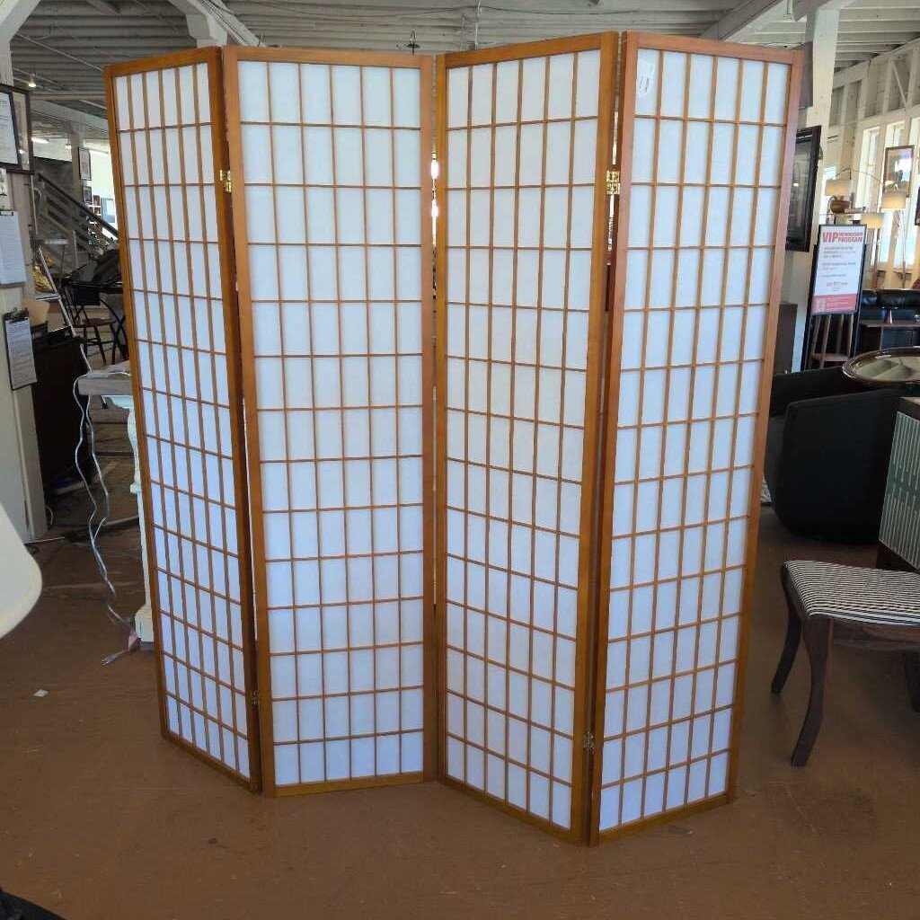 Wooden room divider with white panels in a store setting