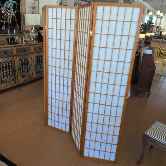 Wooden room divider with white panels in a store setting
