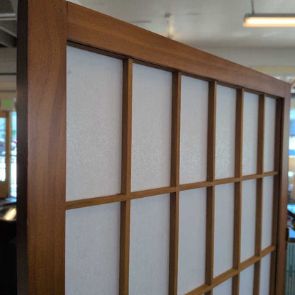 Wooden room divider with white panels in a store setting