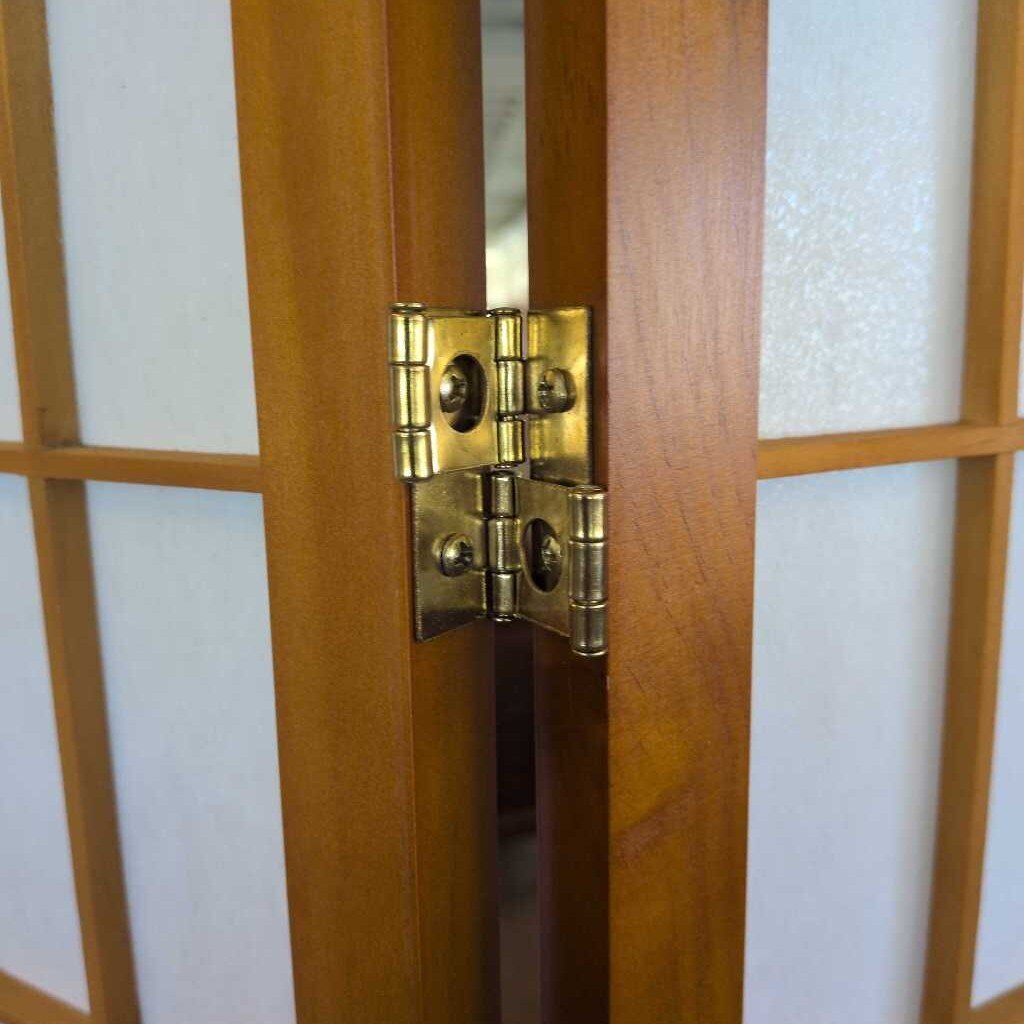 Wooden room divider with white panels in a store setting
