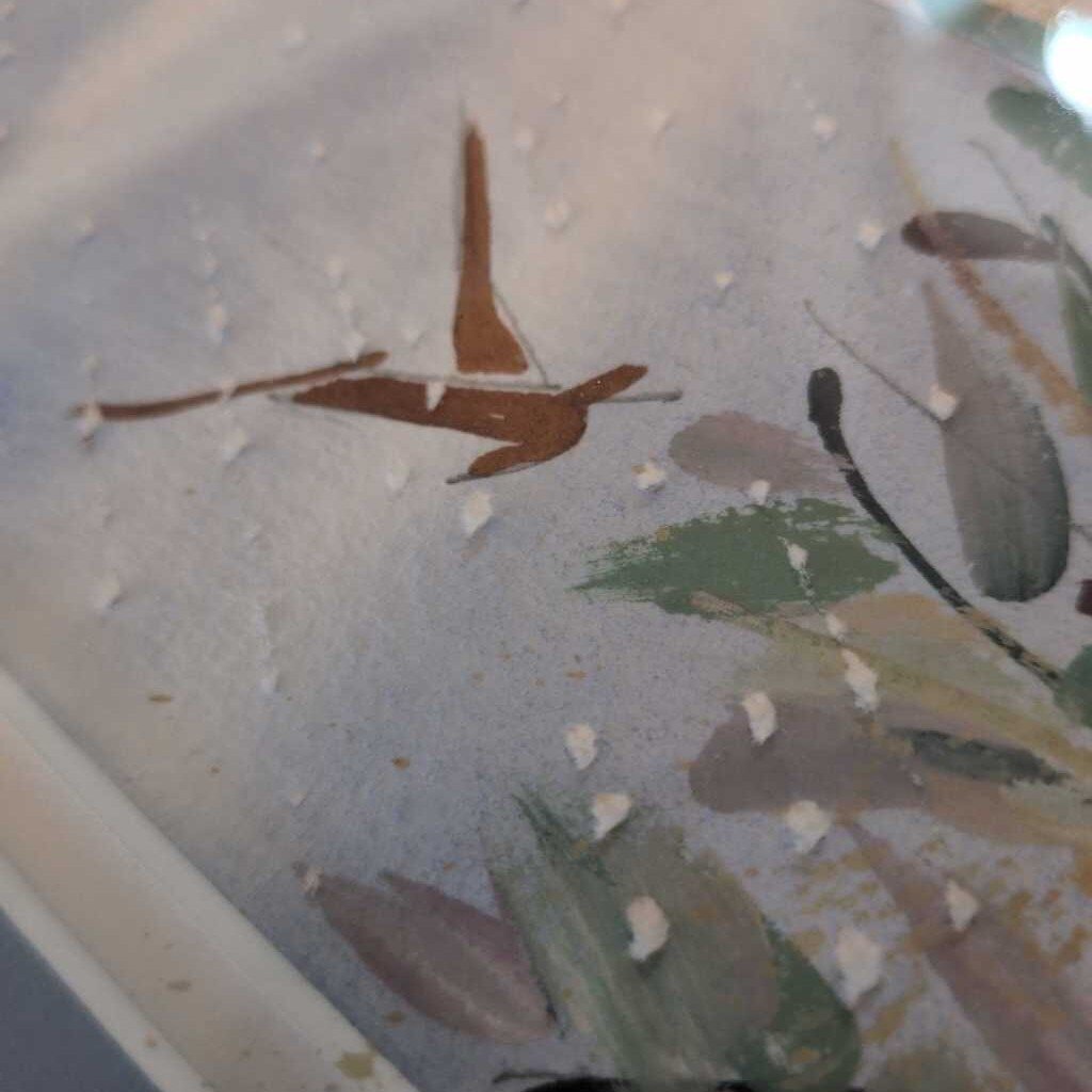 Close-up of a ceramic plate with nature-themed design