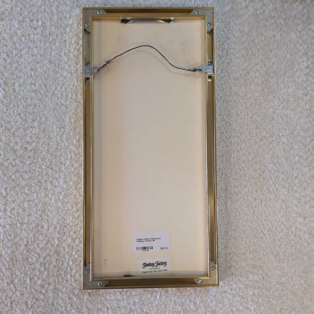 Gold picture frame on a textured wall