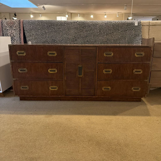 Wooden dresser with multiple drawers in a store setting