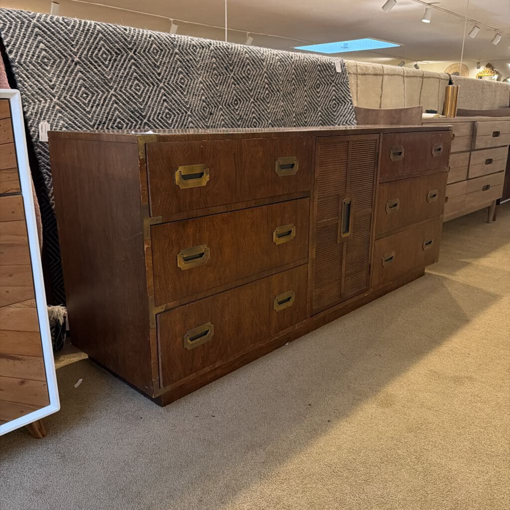 Wooden dresser with multiple drawers in a store setting