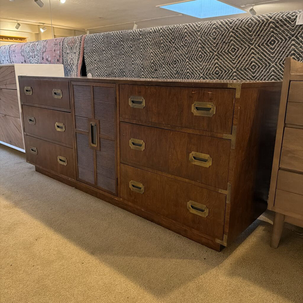 Wooden dresser with multiple drawers in a store setting