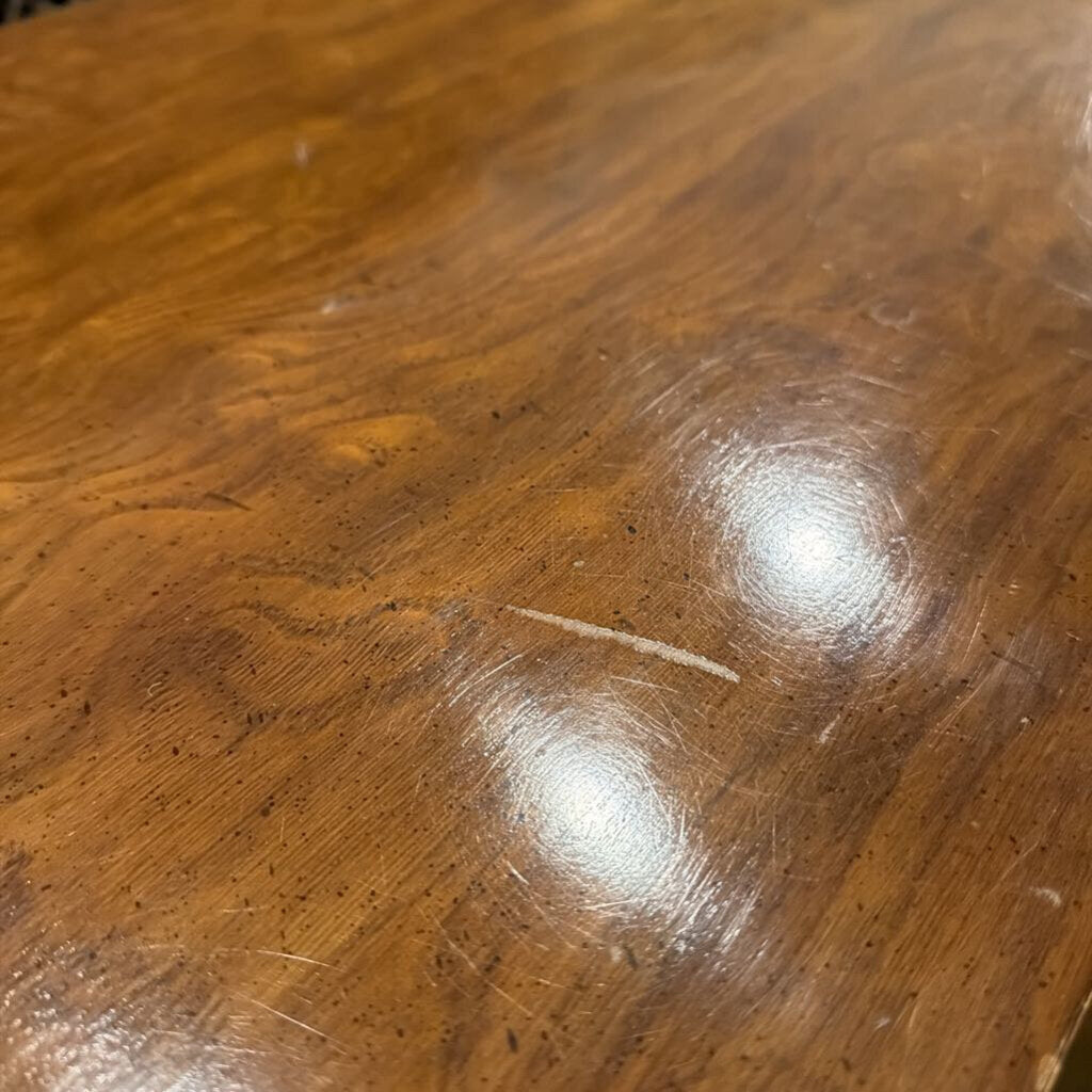 Close-up of a wooden surface with visible scratches and marks