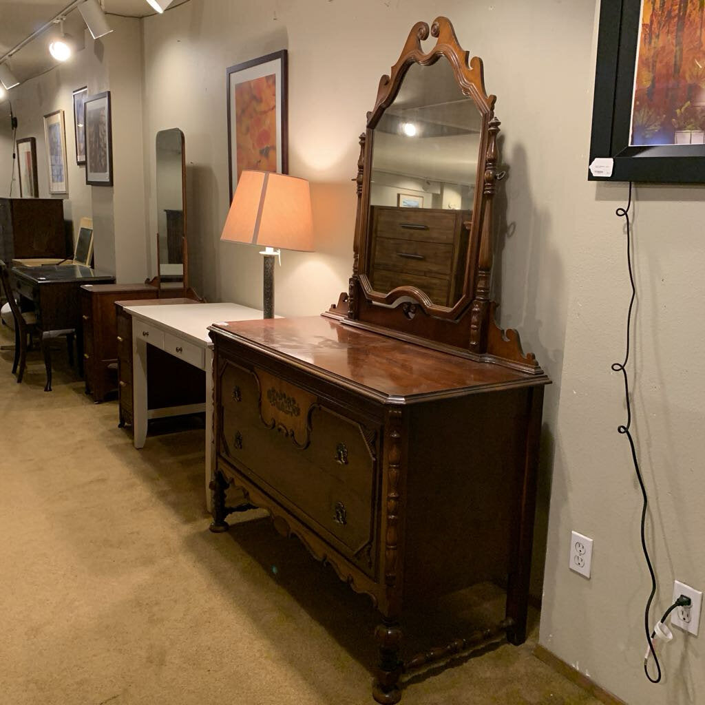 Wooden dresser with mirror in a room setting