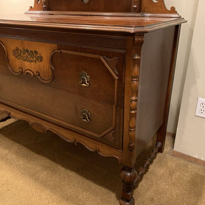 Wooden dresser with intricate carvings in a room setting