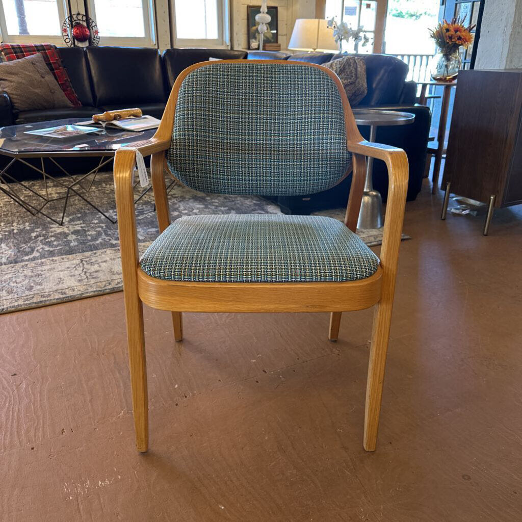 Chair with plaid cushion in a room with furniture and decor
