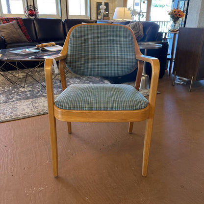 Chair with plaid cushion in a room with furniture and decor