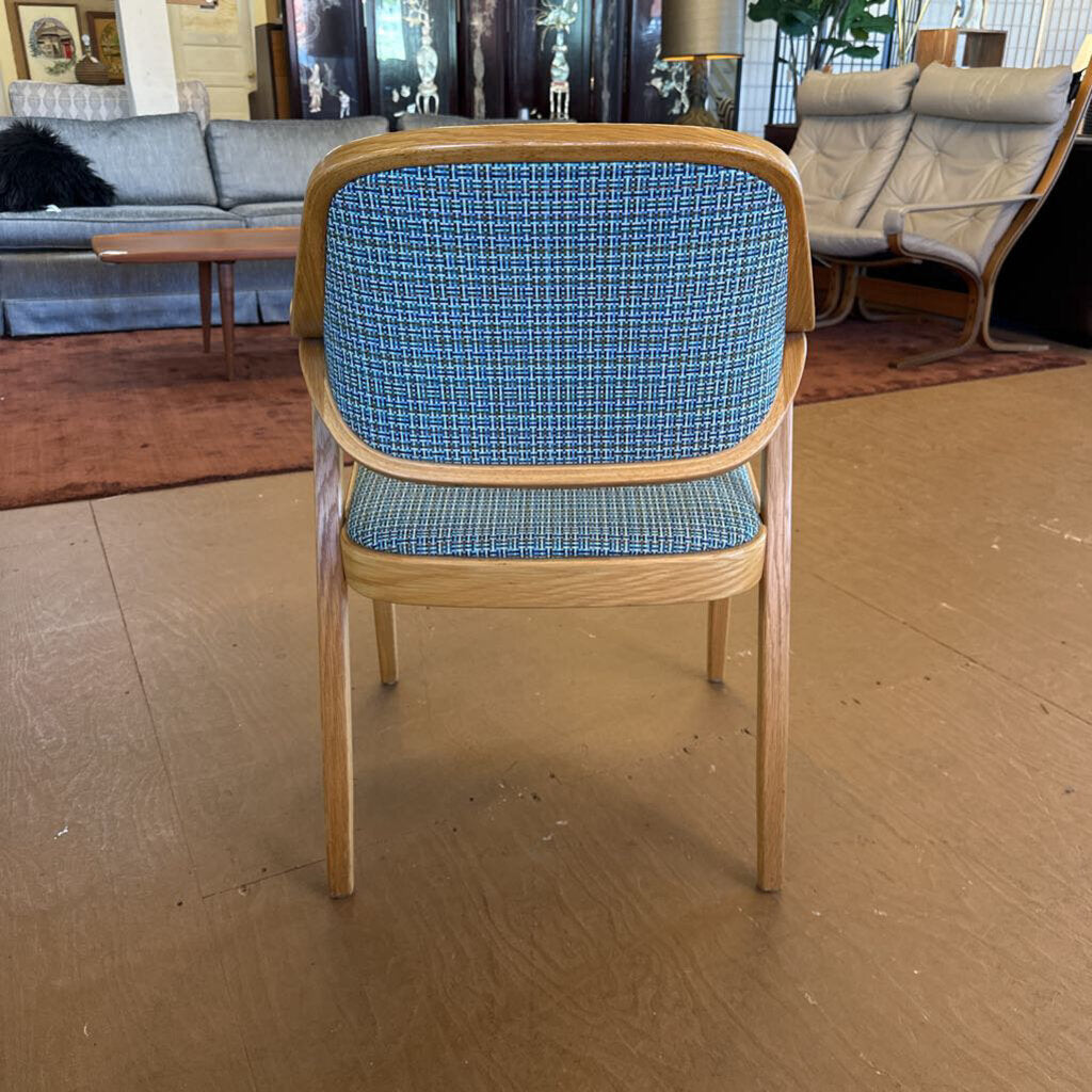 Chair with blue checkered backrest and seat in a room with furniture.