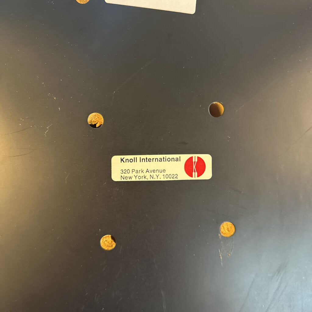Knoll International label on a dark surface with gold stickers.