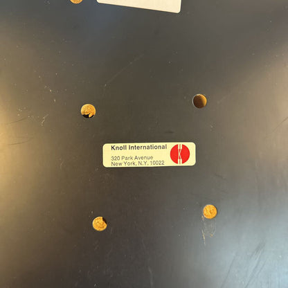 Knoll International label on a dark surface with gold stickers.