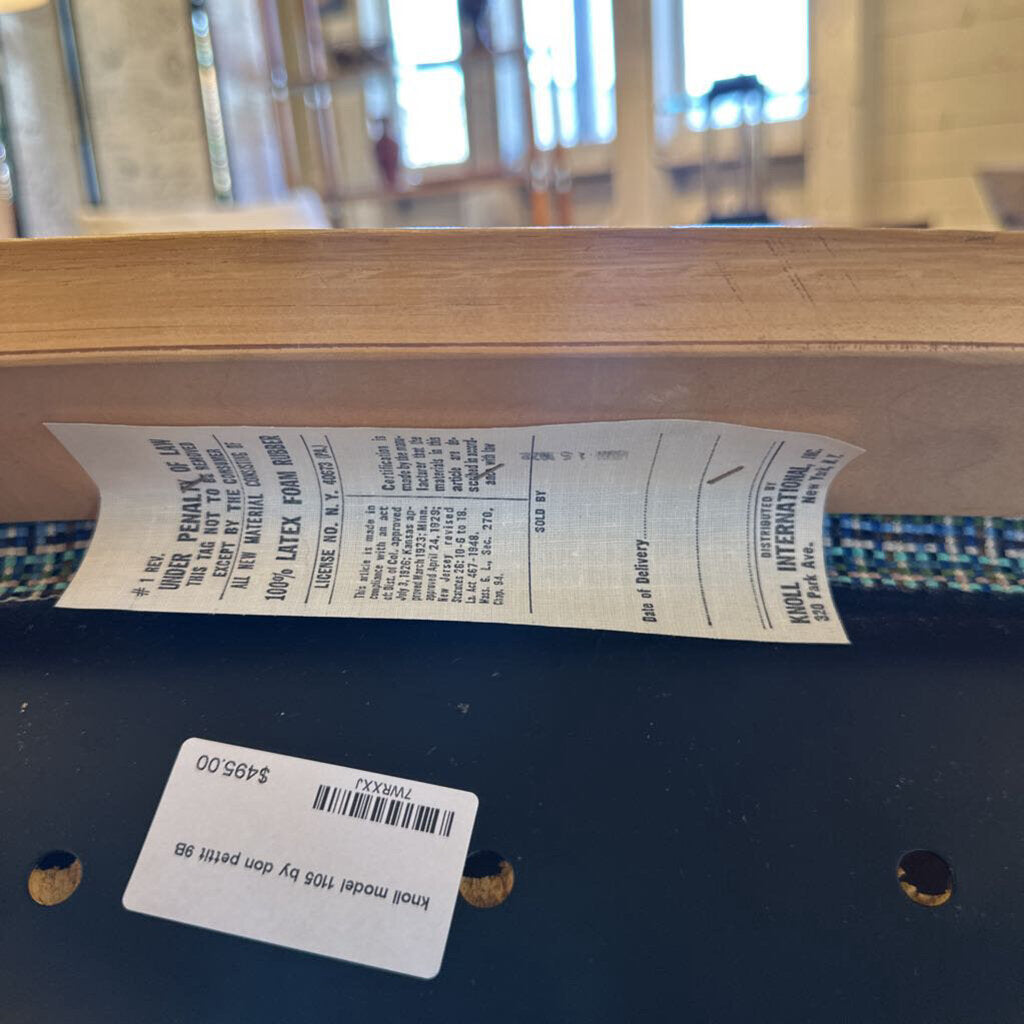 Close-up of a wooden product with a label and text on a blurred background