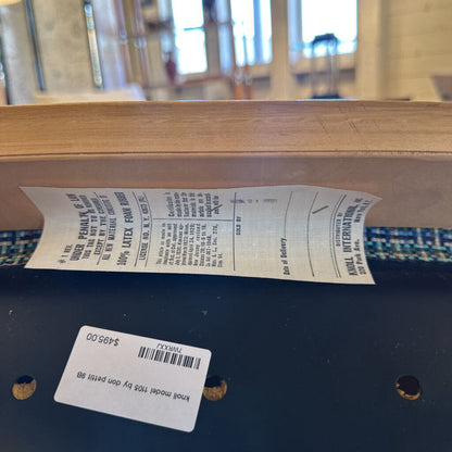Close-up of a wooden product with a label and text on a blurred background