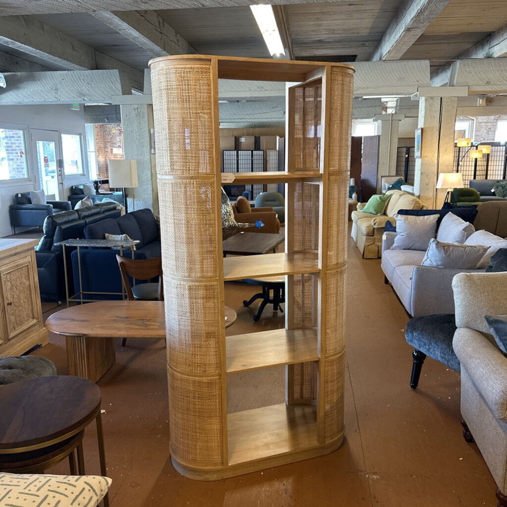 Wooden room divider in a furniture store with various seating arrangements in the background.