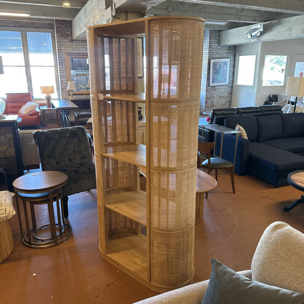 Wooden bookshelf in a living room with furniture and decor