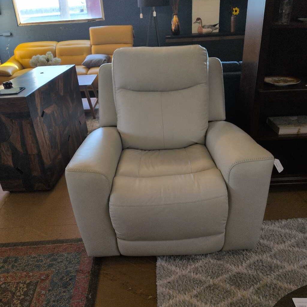 Gray recliner chair in a living room setting with yellow sofa and coffee table.