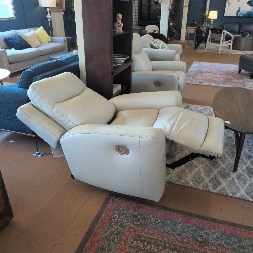 White recliner sofa in a living room setting with furniture and decor.