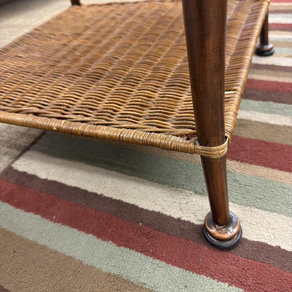 Wicker chair leg on a striped rug