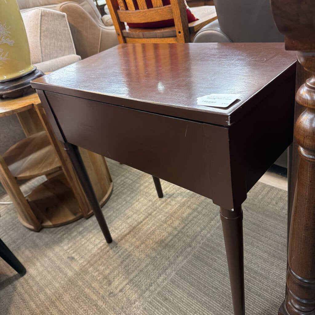 Wooden table with a card on it in an indoor setting