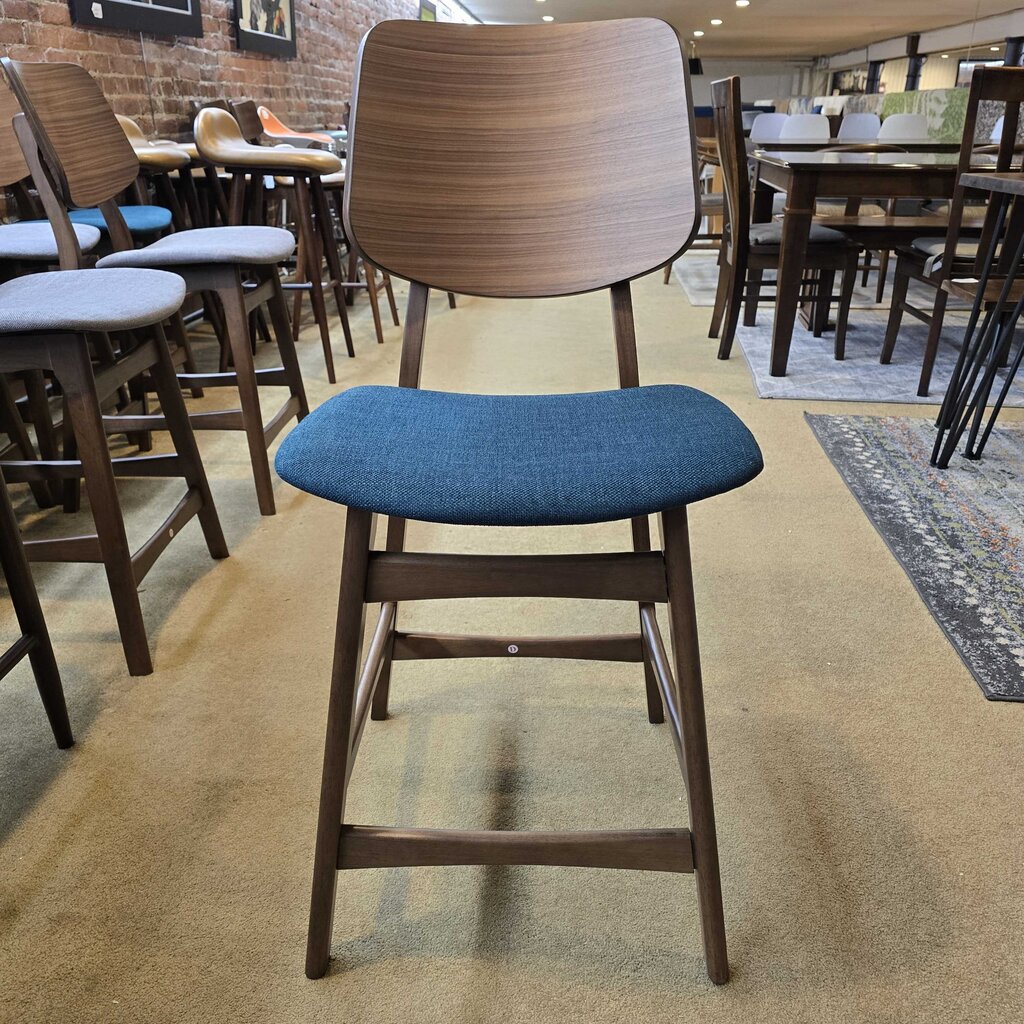 Chair with wooden frame and blue cushion in a restaurant setting
